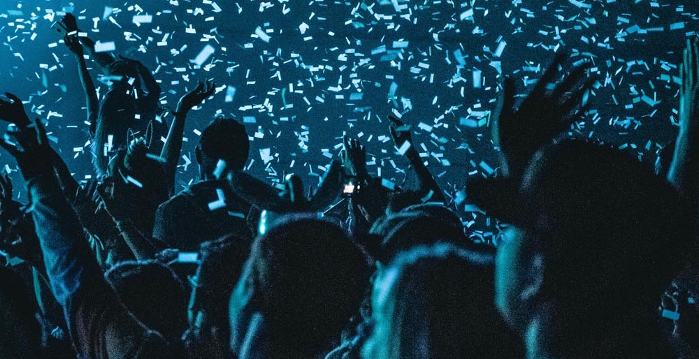blue confetti showering down on attendees at concert