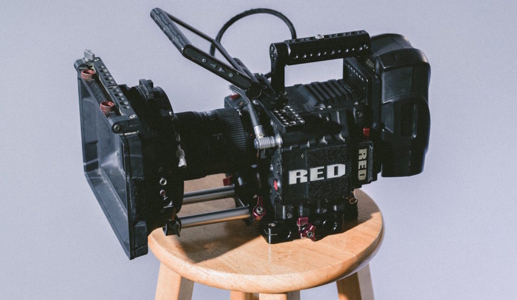 black professional video camera on wooden stool